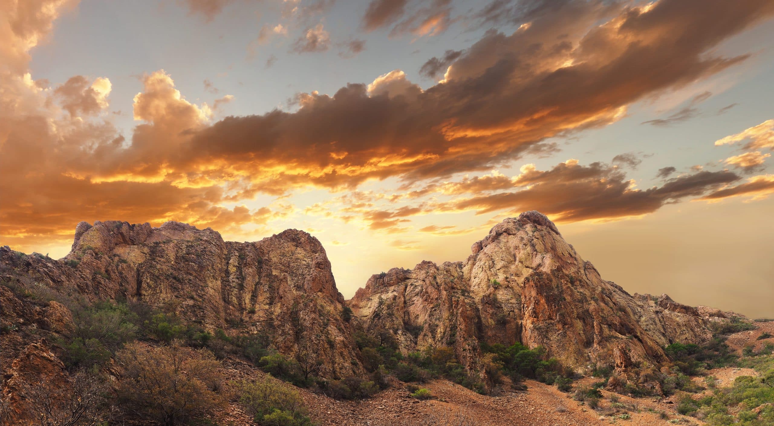 Rock outcrops above the desert at sunset